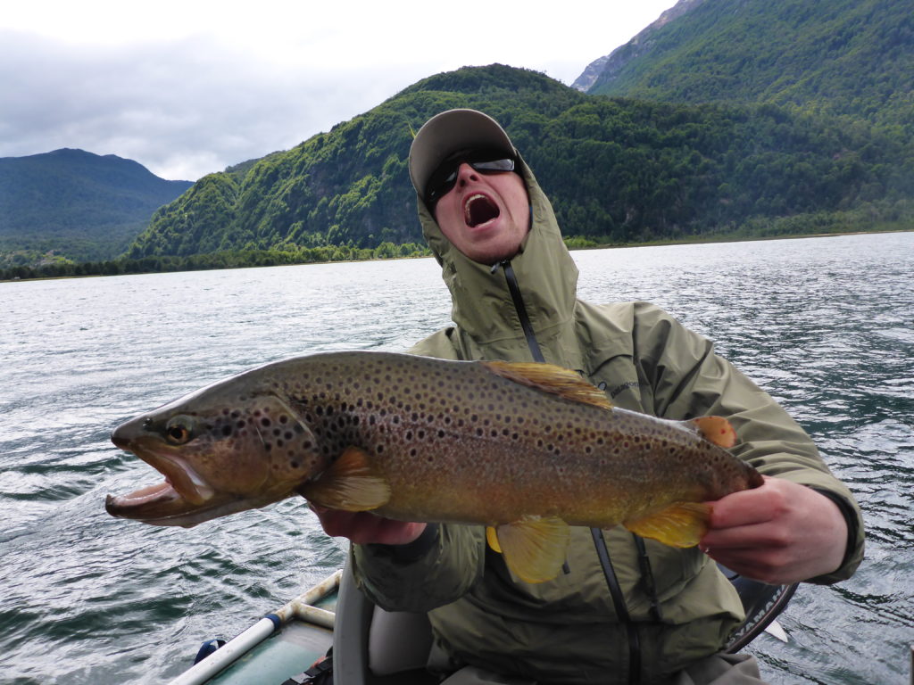 A happy fisherman with a huge trout