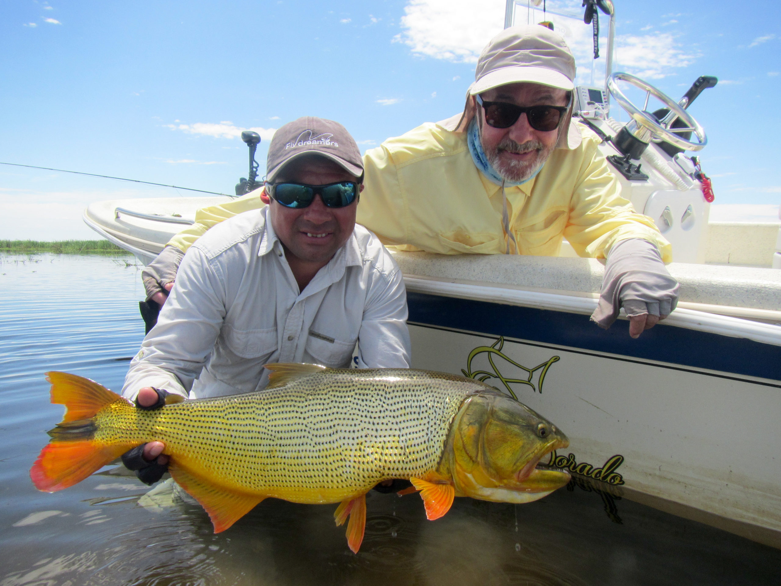 An angler and his guide show off a Golden Dorado.