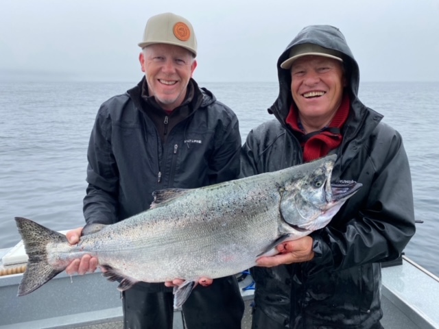 Fisherman show off a King Salmon that they caught in British Columbia.