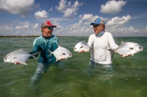 Fisherman show off two permit each, four total, whilst fishing the Ascension Bay in Mexico.