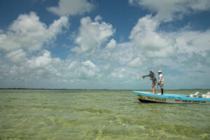 fly fisherman casts off the end of a boat in the Ascension Bay