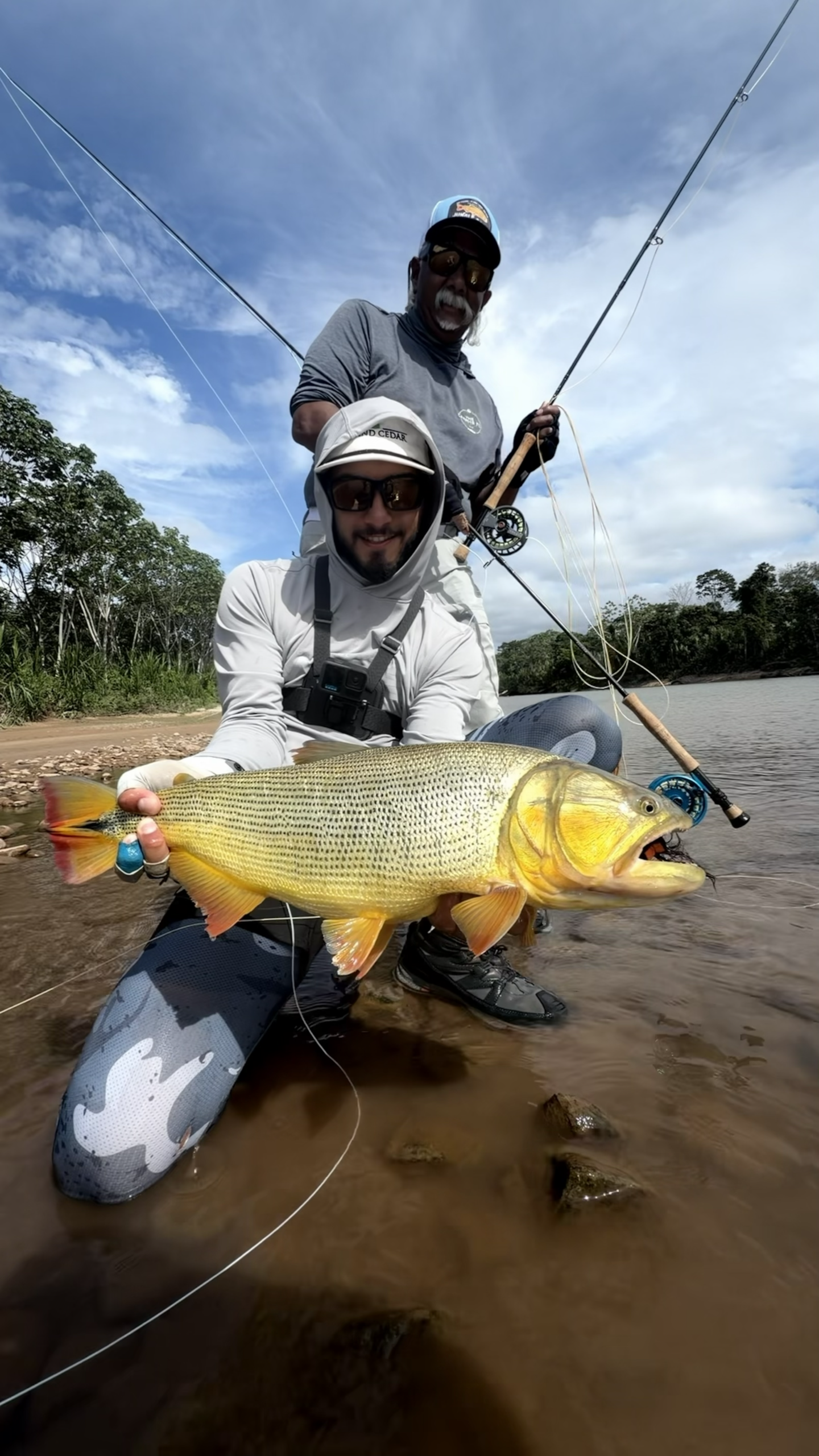two anglers show their golden dorado catch in the Amazon Jungle
